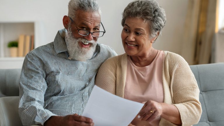 Senior couple reviewing New York Medicaid eligibility documents for 2025