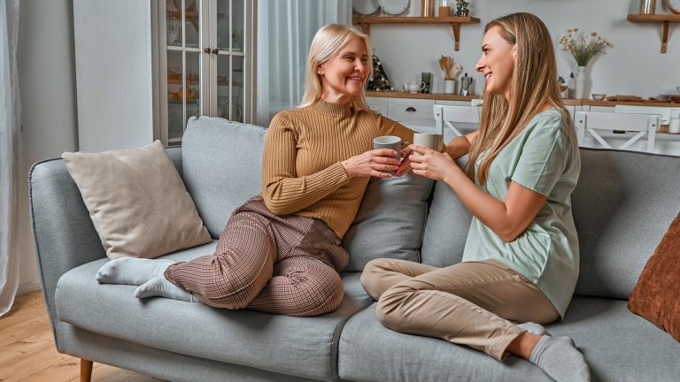 Adult daughter having a calm conversation with aging parents about estate planning documents